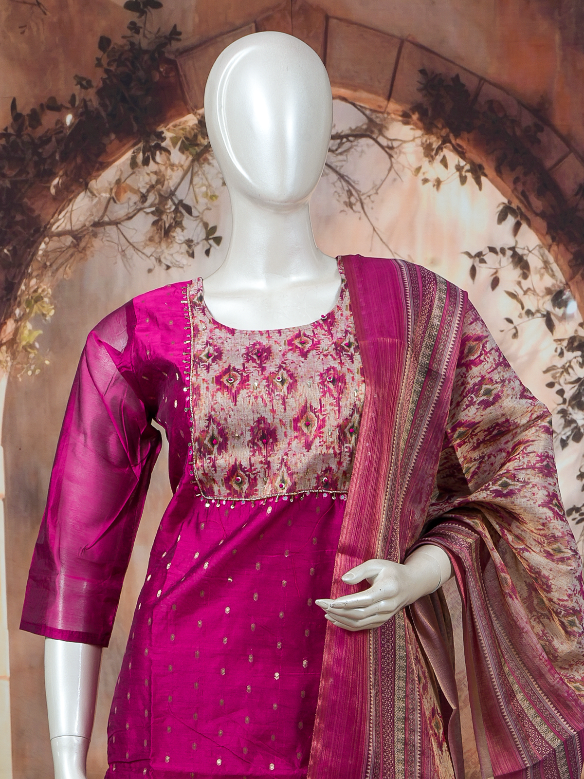 Magenta art silk kurti set with ikat-print yoke, zari booties, and matching printed dupatta