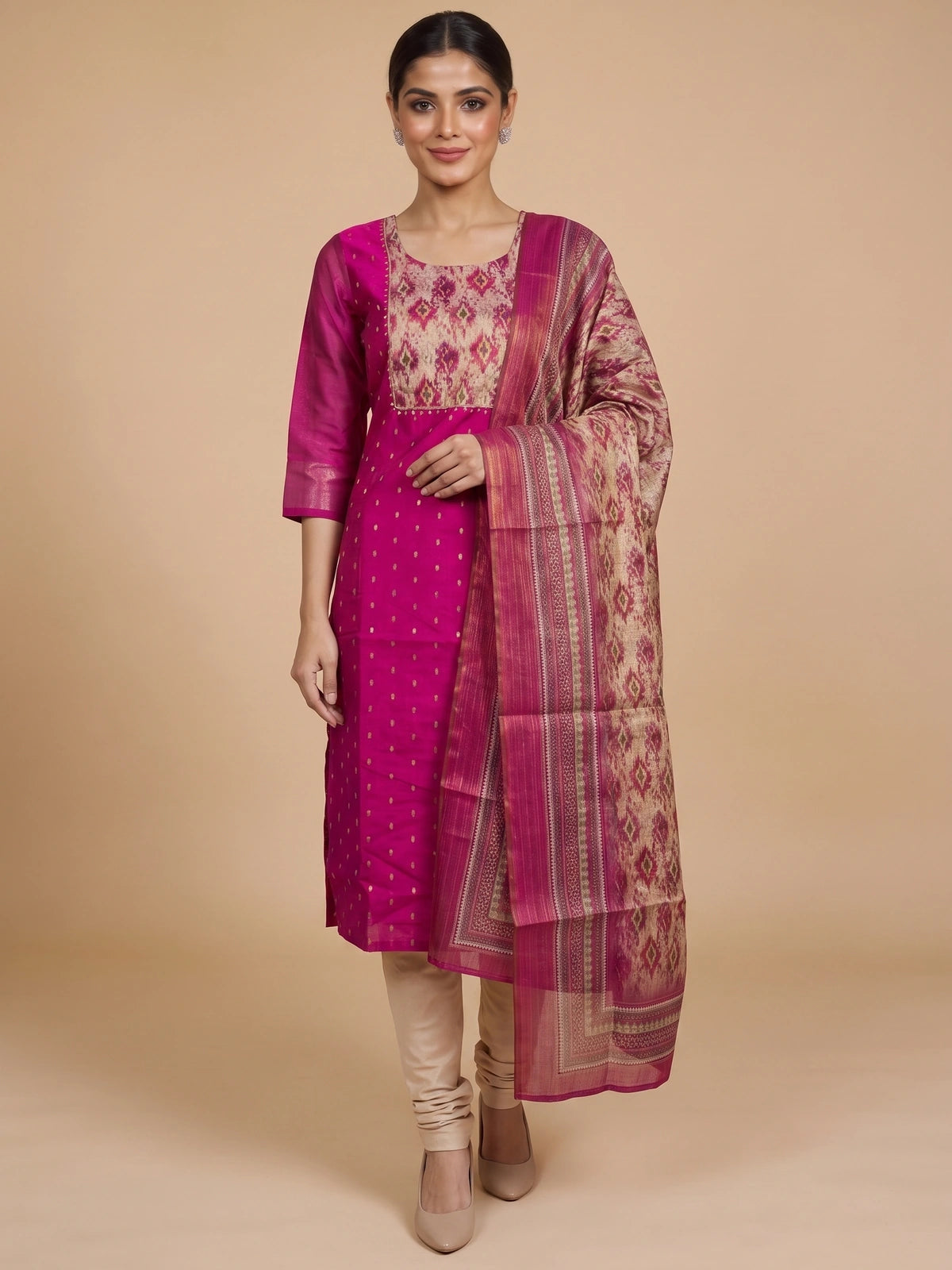 Magenta art silk kurti set with ikat-print yoke, zari booties, and matching printed dupatta